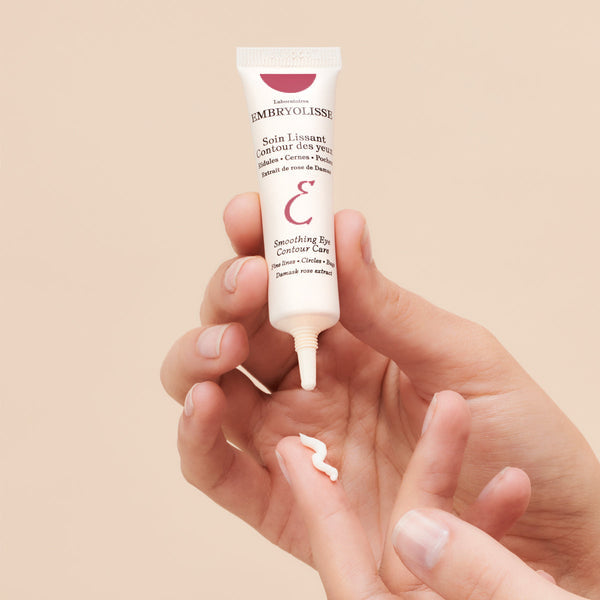 Hand holding Embryolisse skincare Smoothing Eye Contour Cream form the Anti-Aging Colelction