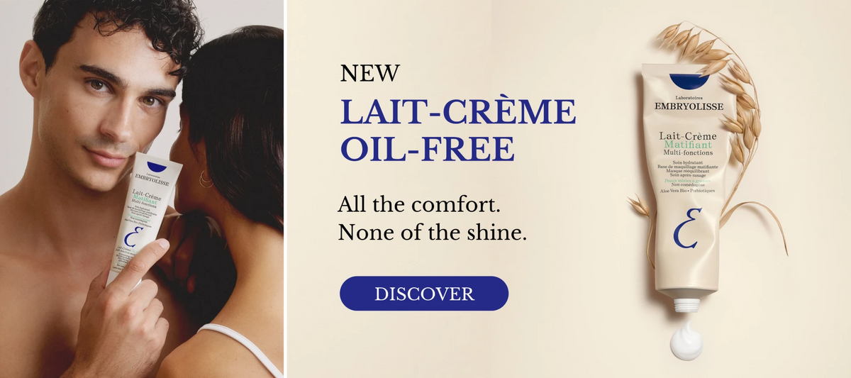 New Lait-Crème Oil-Free by Embryolisse. All the comfort. None of the shine. A man holds the tube to his cheek, next to the tube laid flat with an oat sprig and a dollop of cream.
