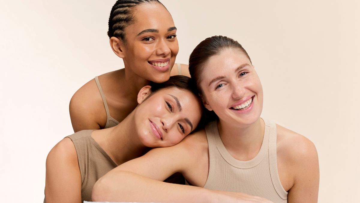 3 women smiling, Year-Round Glowing Skin: Radiance-boosting Skincare Tips.