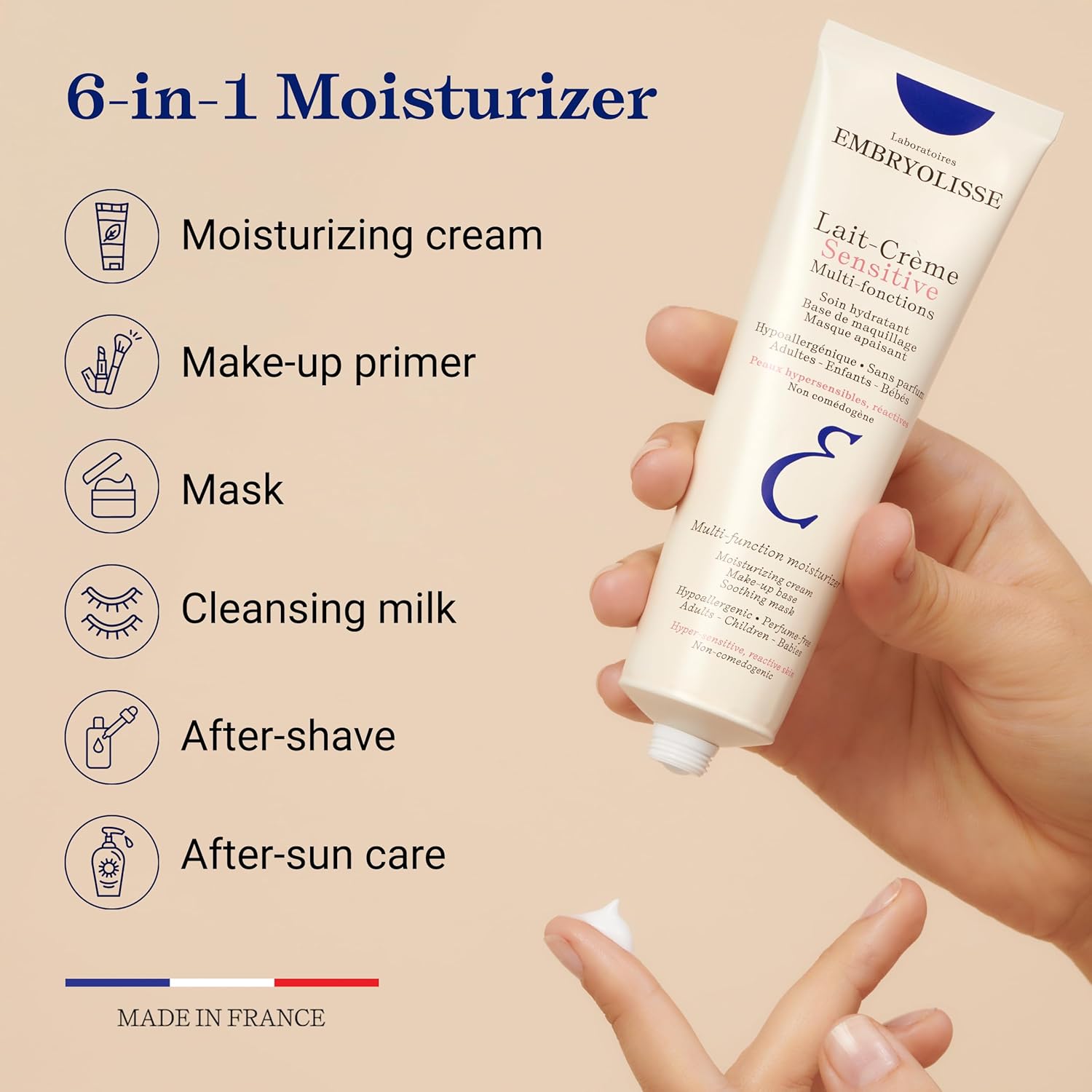 Embryolisse Lait-Crème Sensitive 6-in-1 moisturizer tube held by a hand with product features listed on a beige background.